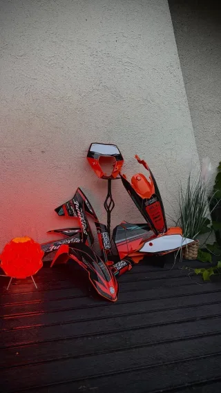 Orange motorcycle plastics and graphics arranged for a reel